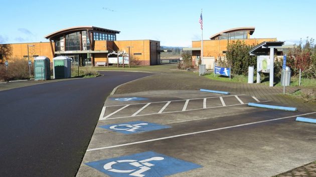 Three accessible parking spaces, including one van-accessible space, and parking lot and visitor center at Tualatin River National Wildlife Refuge.