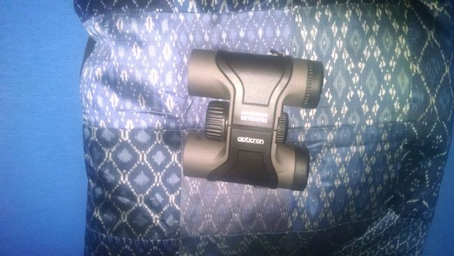 Opticron Traveller BGA Mg 8x32s on a blue pillow